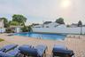View of pool with a fenced backyard, a patio, a diving board, and an outdoor structure