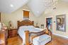 Bedroom featuring light wood-style floors, a spacious closet, recessed lighting, a chandelier, and lofted ceiling