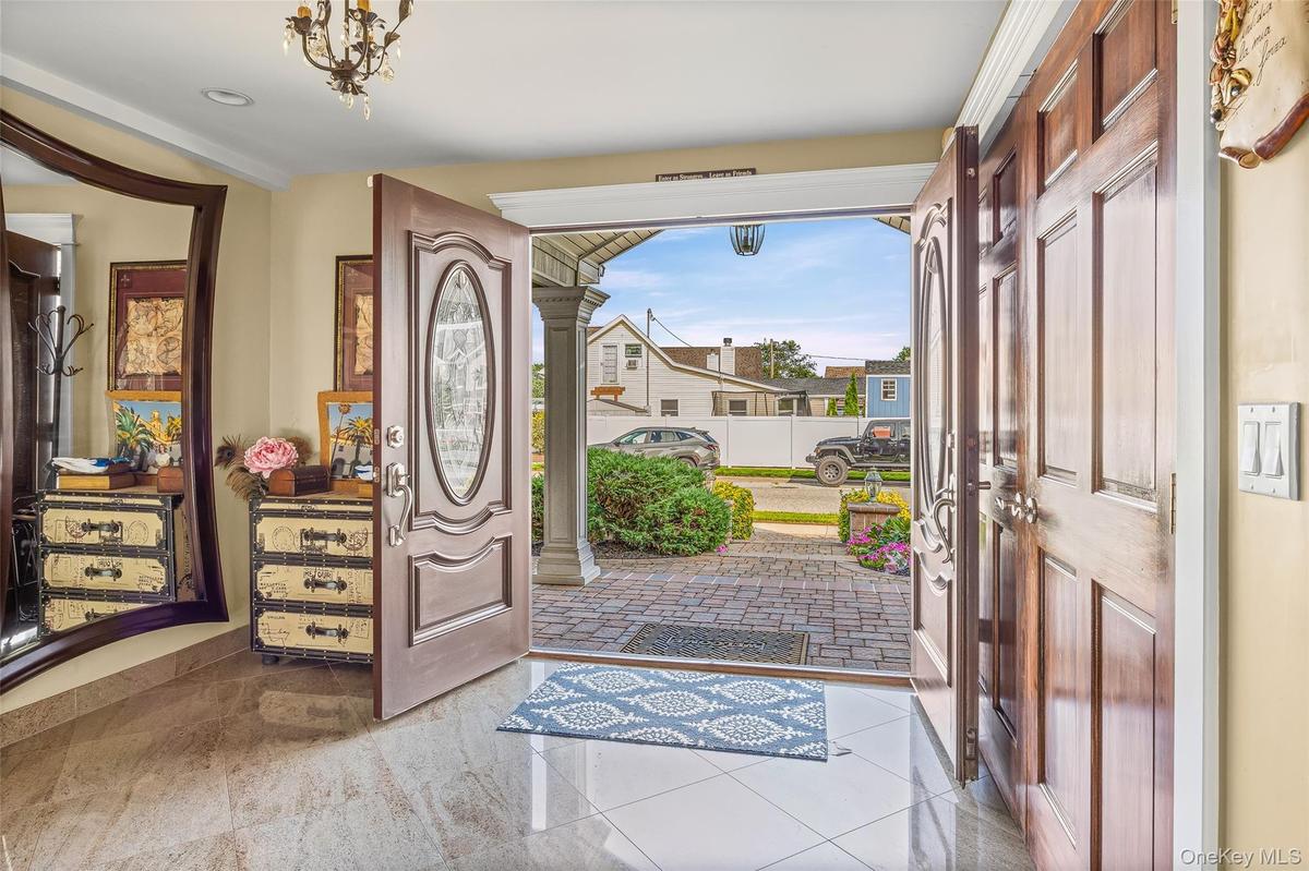 Foyer entrance with ornate columns and tile patterned floors