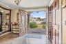 Foyer entrance with ornate columns and tile patterned floors