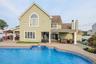 Back of house featuring a patio, outdoor lounge area, and a chimney