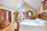 Bedroom with light wood-type flooring, high vaulted ceiling, a chandelier, and recessed lighting