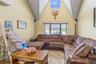 Living room featuring high vaulted ceiling