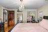 Bedroom with wood finished floors, a closet, and a chandelier