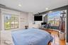 Bedroom with an office area, light wood-style flooring, and recessed lighting