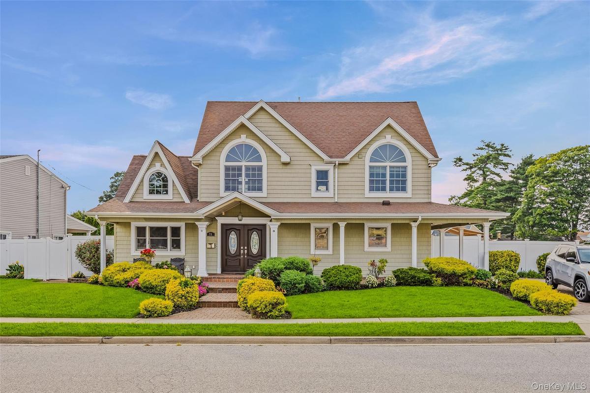 View of front of property with a porch and roof with shingles