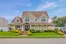 View of front of property with a porch and roof with shingles