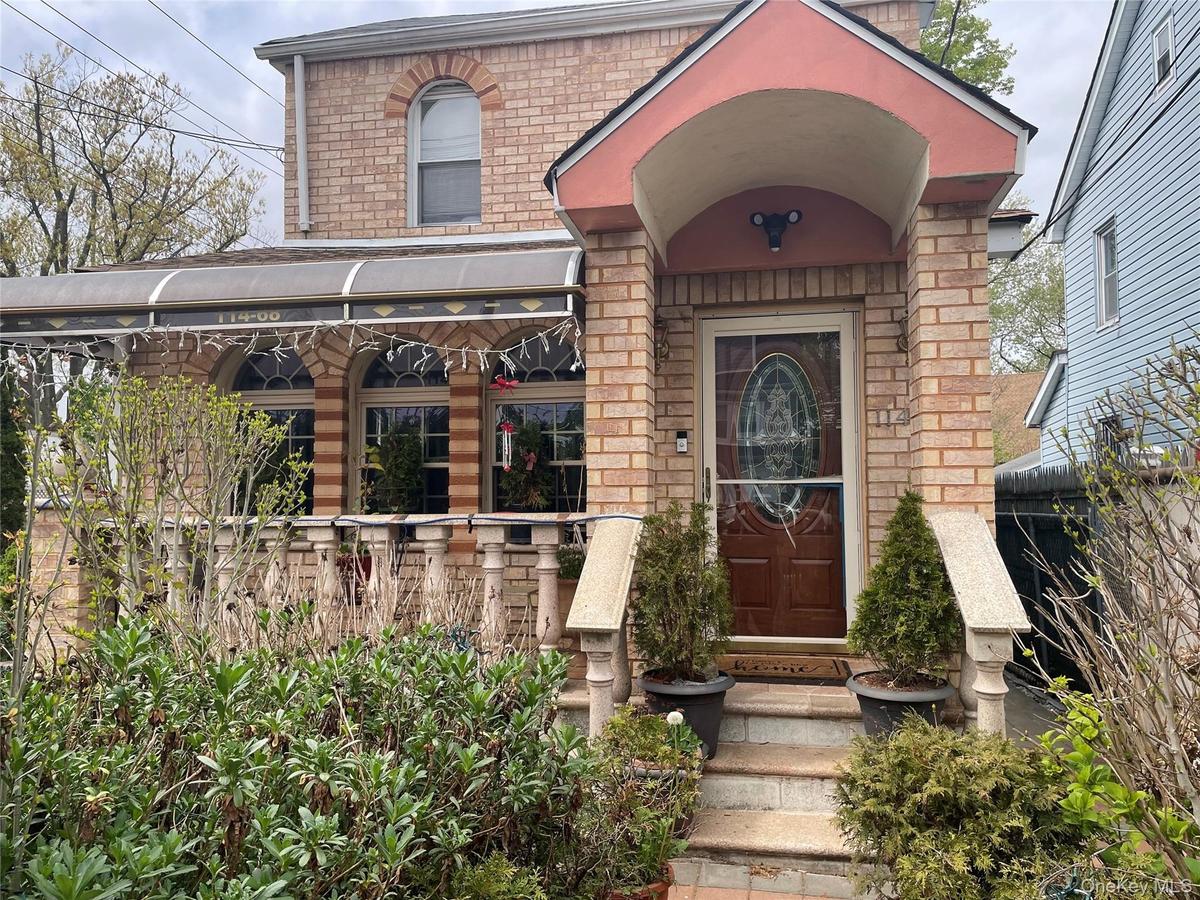 View of exterior entry featuring brick siding