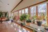 The beautiful family room features gleaming hardwood floors and an abundance of windows that fill the space with natural light, creating a bright, war