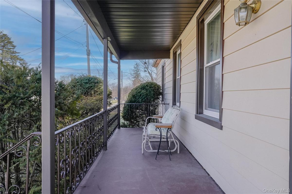 The large front porch adds timeless charm and curb appeal to this multi-family home, offering a welcoming space to relax, enjoy the neighborhood, and 