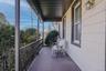 The large front porch adds timeless charm and curb appeal to this multi-family home, offering a welcoming space to relax, enjoy the neighborhood, and 