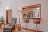 A charming breakfast bar seamlessly connects the family room to the kitchen, creating an open and inviting space perfect for casual dining, entertaini