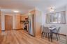 First floor custom kitchen features beautiful wood cabinetry, granite countertops, a stylish backsplash, and rich wood floors, combining warmth, elega