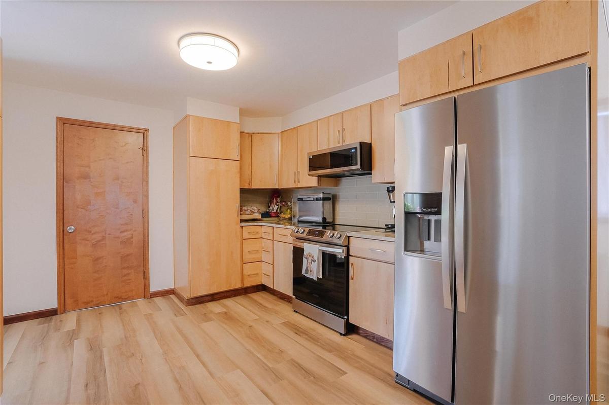 r. Rich wood floors bring warmth to the space, while the open layout makes the kitchen perfect for both everyday living and entertaining.