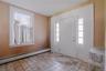 Step into a spacious tiled foyer that creates a warm and inviting first impression, welcoming you into the expansive first-floor unit with comfort and