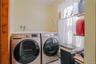 The first-floor laundry room offers exceptional convenience and functionality, featuring a washer and dryer along with abundant storage space to keep 