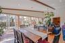 The dining area in the first-floor family room is filled with natural light from an abundance of windows and features beautiful hardwood floors, creat