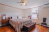 The expansive first-floor primary bedroom offers a peaceful retreat with generous space, abundant natural light, and plenty of room to create your own