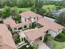 Separate Guest House with a 2 car garage and a golf cart bay with garage door on back side of the garage with a pavered path leading to the golf cours