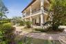 Backside of the guest house with a balcony and covered lanai space