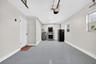 Single garage with garage door opened. Fresh epoxy flooring.  Garage stacked washer and dryer.