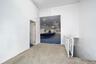 Corridor featuring carpet floors, a paneled ceiling, and an upstairs landing