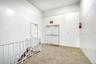 Hallway with carpet flooring and an upstairs landing