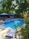 The expansive patio and beautiful in-ground pool create an incredible outdoor retreat, perfect for entertaining, relaxing, and enjoying warm summer da