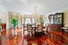 Spacious room featuring intricate parquet wood flooring, a crystal chandelier, recessed lighting, crown molding, and wainscoting