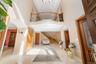 Entrance foyer with arched walkways, high vaulted ceiling, stairs, and recessed lighting