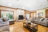 Living area with plenty of natural light, a fireplace, ornamental molding, light wood-style floors, and recessed lighting