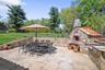 View of patio featuring a fireplace and outdoor dining area