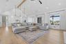 Vaulted ceiling with an exposed wood beam, recessed lighting, and light wood-finish flooring