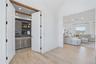Dedicated office space featuring exposed wood beams, recessed lighting, built-in cabinetry, and a textured area rug