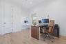 Bright room with light wood-finish flooring and a white color palette