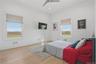 Bright room featuring two large windows, wood-finish flooring, a ceiling fan, and recessed lighting