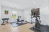 Versatile bonus room featuring light wood-finish flooring, recessed lighting, and a single window with a blind