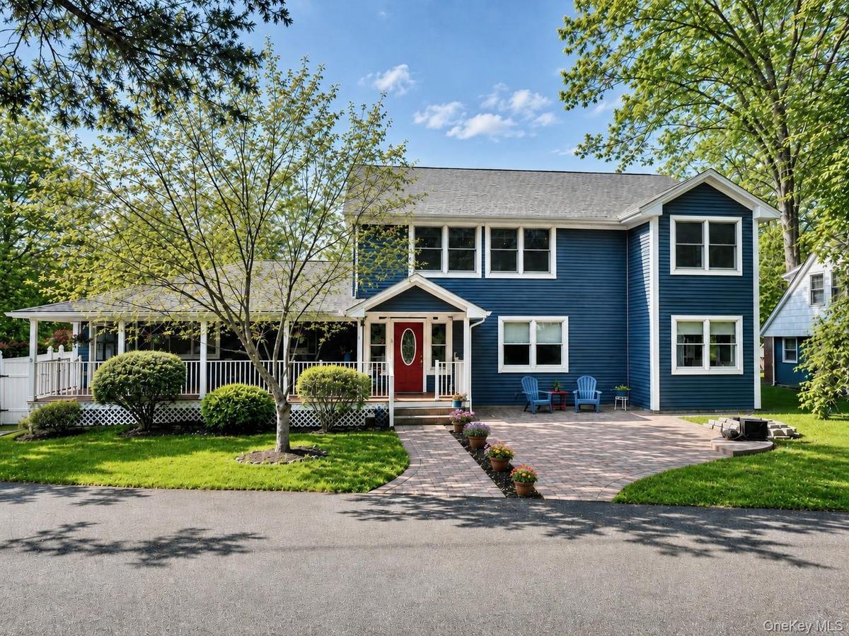 Welcome to the main house with a wonderful rocking chair front porch and expansive driveway that fits 5 cars!