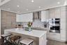 Designer backsplash, kitchen cabinet/drawer pulls, hardwood flooring included in many upgraded features.