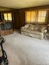 Large den for family and friends fireplace with wood mantle and paneling