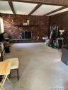 Brick fireplace with a dark wood mantel and a decorative fire screen