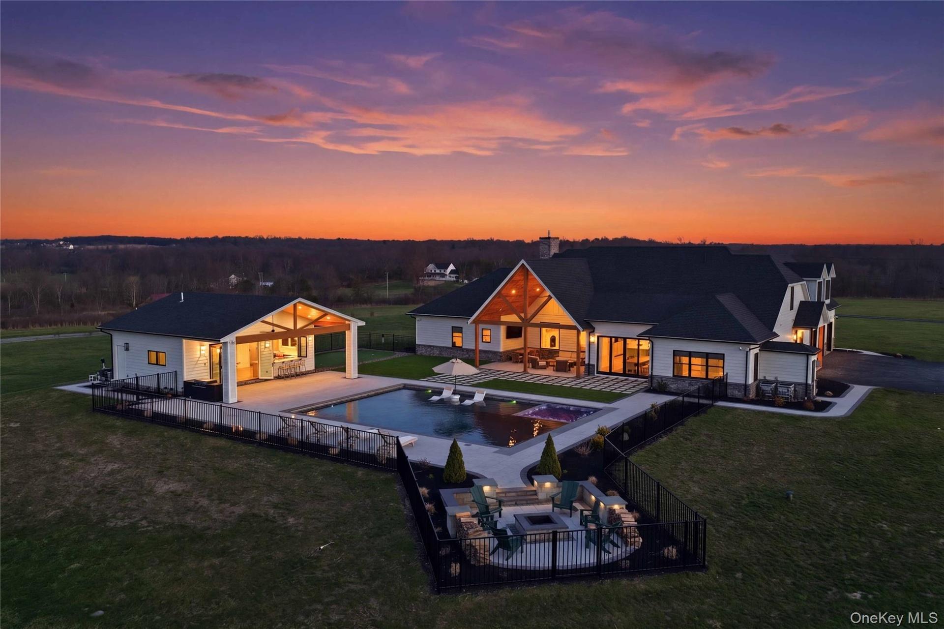 Modern exterior featuring white siding, dark roofing, and exposed wood beam accents