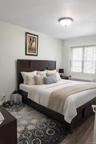 Bedroom with radiator heating unit and wood finished floors