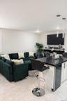 Living room featuring beverage cooler and light marble finish floors