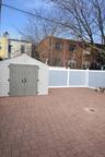 View of patio with a storage shed
