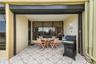 Electric shutters protect the patio and windows