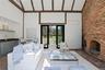 Interior of pool house with floor to ceiling brick fireplace, wet bar and full bath
