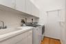 Interior laundry room with washer, dryer, and utility sink.