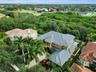 Manicured palms, vibrant gardens, and an expansive paver drive elevate the property’s commanding presence
