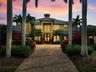 Elegant Mediterranean residence offering timeless curb appeal, refined architectural details, and beautifully manicured tropical landscaping